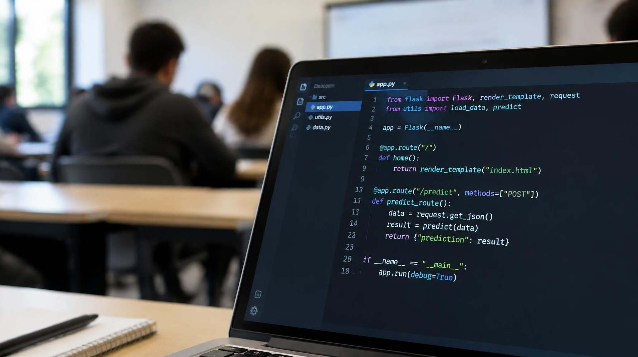 Close-up of a laptop screen showing a code editor with colorful syntax