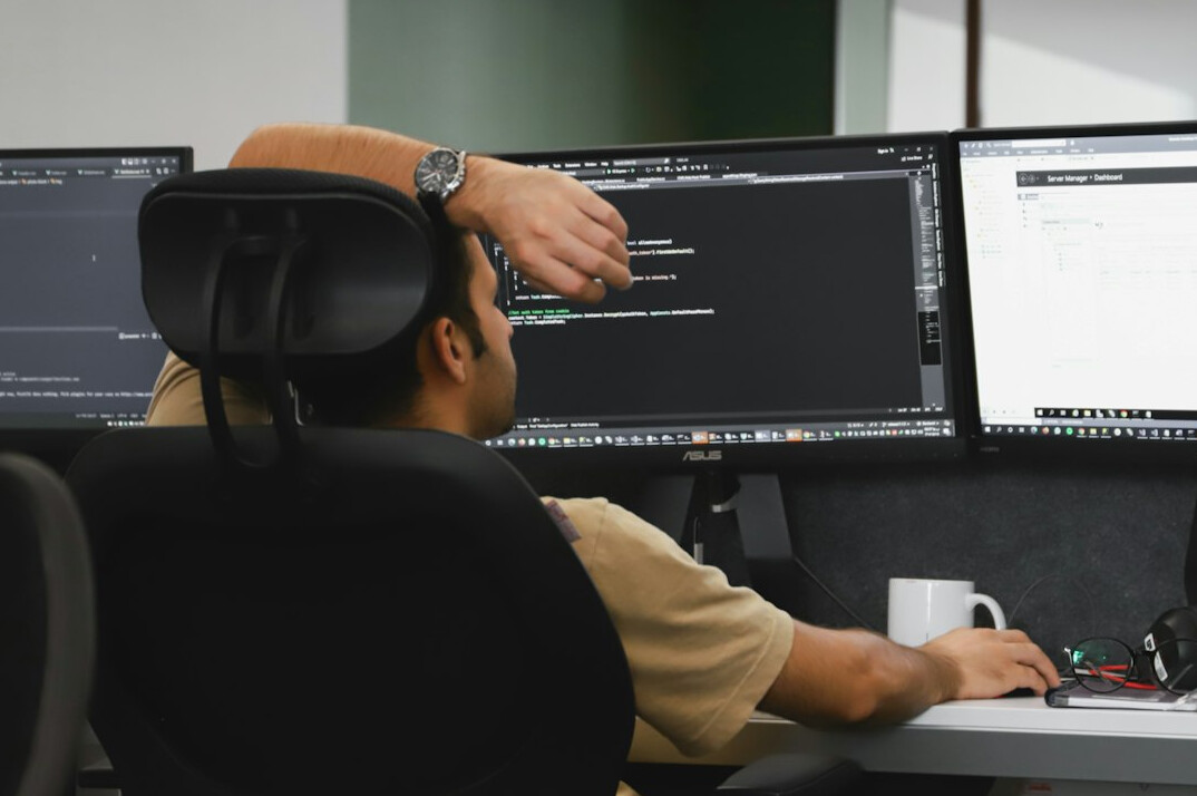 programmer coding at desk